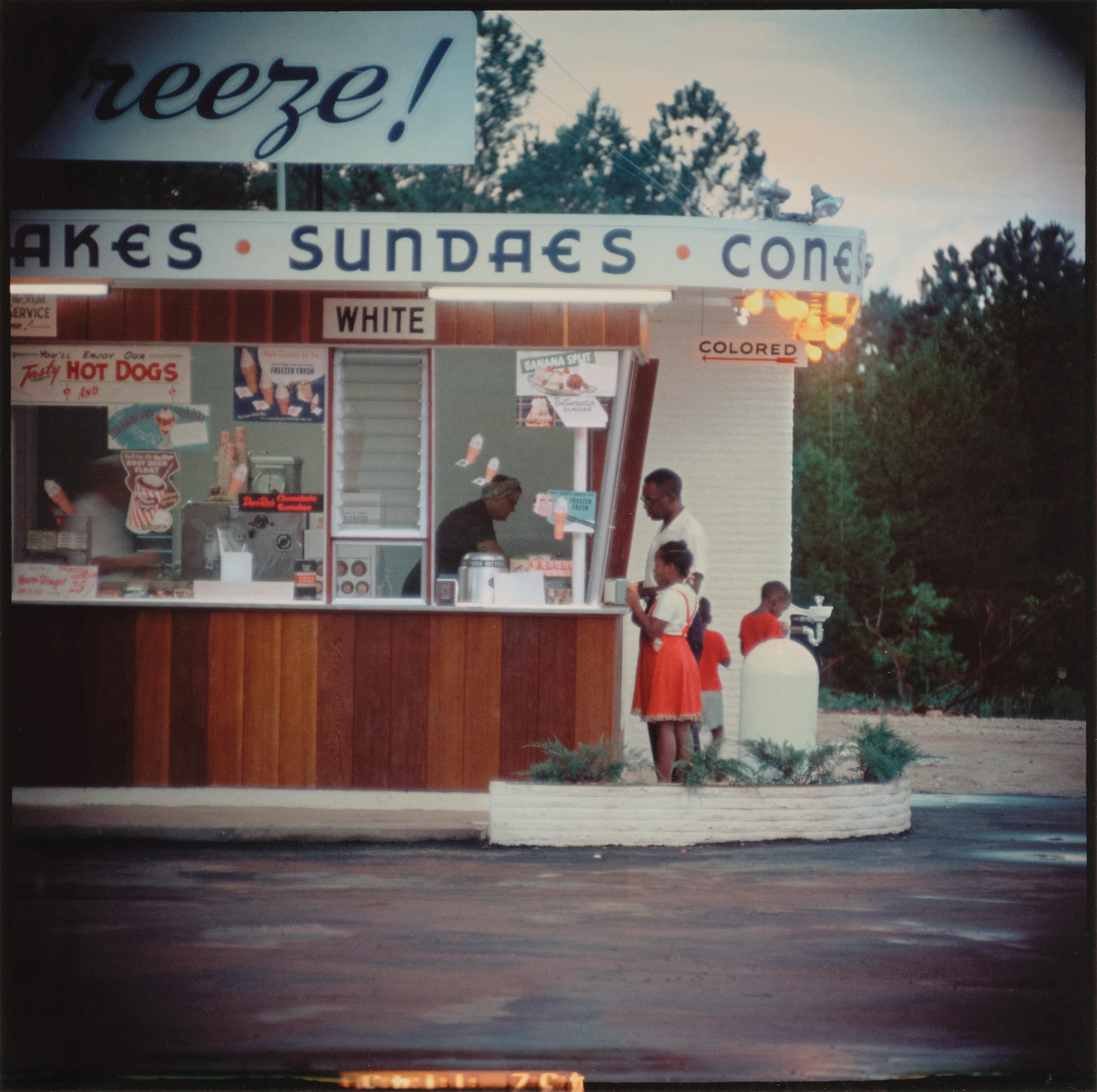 color photograph of people outside a segregated diner 